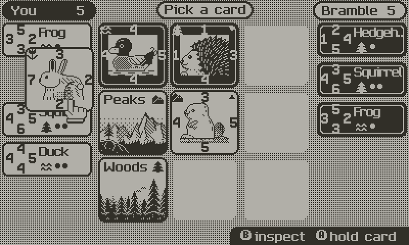 Holding B to inspect a card in hand: numbers, habitat and a note.
